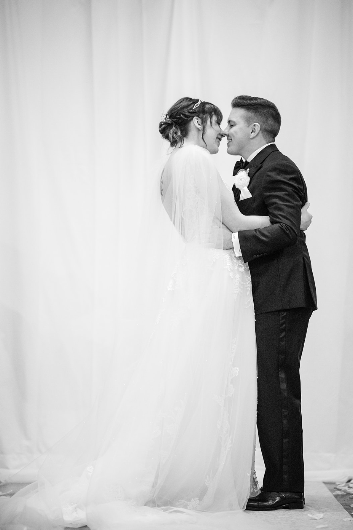 Bride and groom embracing and smiling